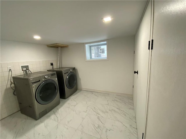 clothes washing area featuring washer and dryer