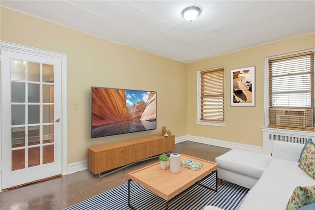 living room with radiator and dark hardwood / wood-style floors