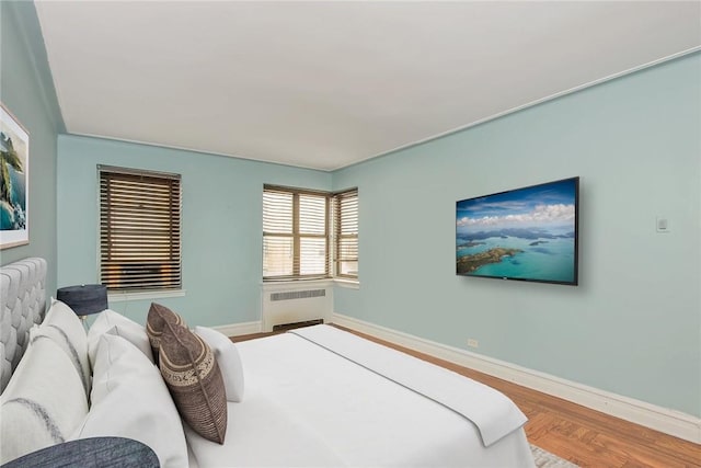 bedroom featuring wood-type flooring and radiator