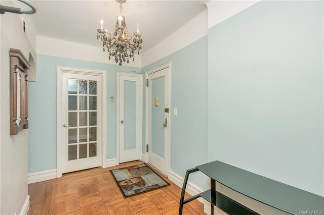 doorway with parquet floors and a notable chandelier