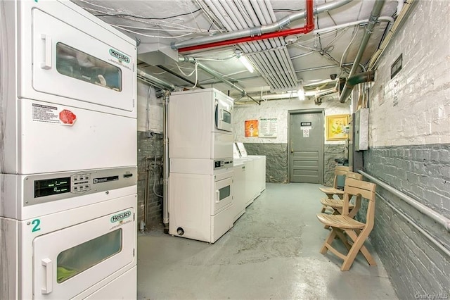 basement with electric panel and stacked washer and dryer