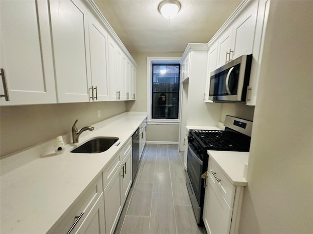 kitchen with sink, white cabinetry, and stainless steel appliances