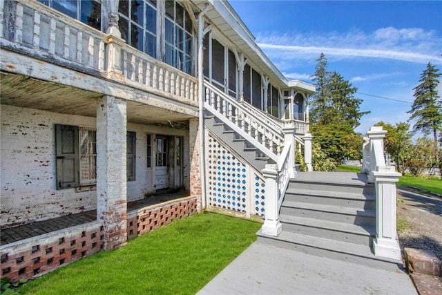 exterior space featuring a sunroom and a yard