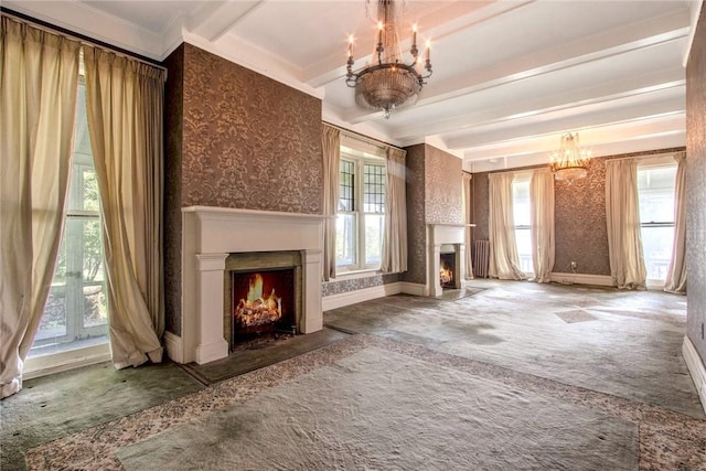 unfurnished living room featuring beamed ceiling, carpet flooring, a chandelier, and a wealth of natural light