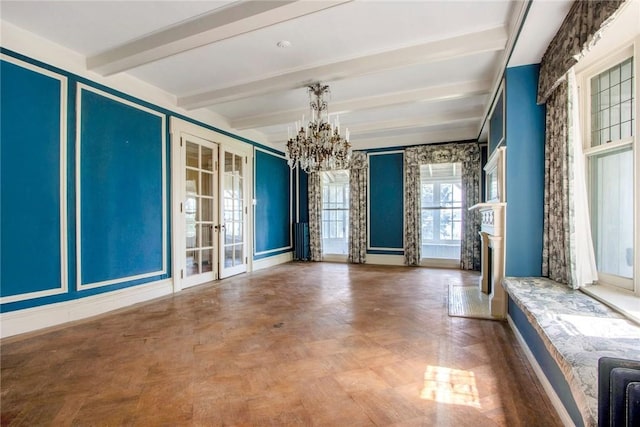 empty room featuring parquet flooring, beam ceiling, and an inviting chandelier