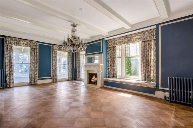 unfurnished living room with beam ceiling, radiator heating unit, a chandelier, and plenty of natural light