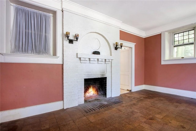 unfurnished living room featuring crown molding