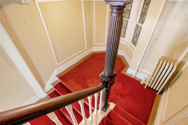 stairs featuring carpet flooring