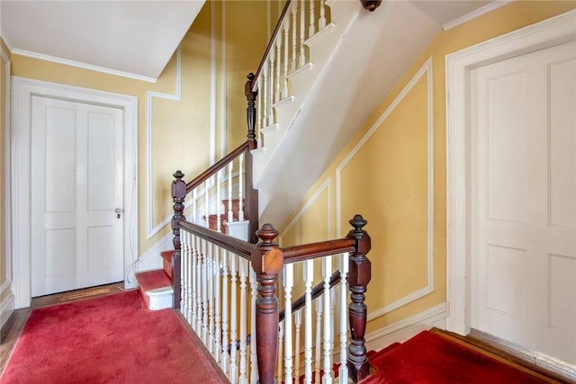 staircase with carpet flooring and ornamental molding