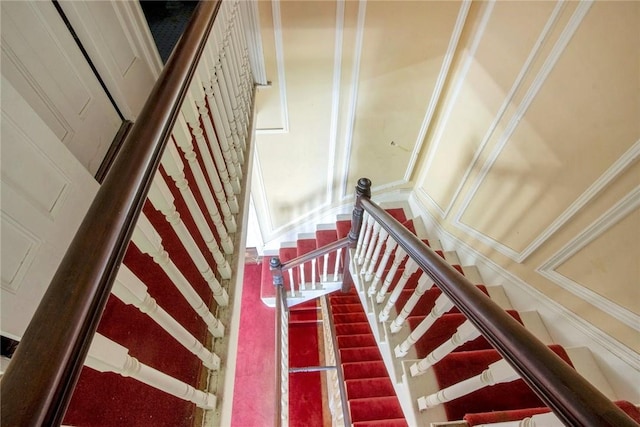 stairs featuring crown molding