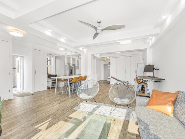 living room featuring ceiling fan and hardwood / wood-style floors