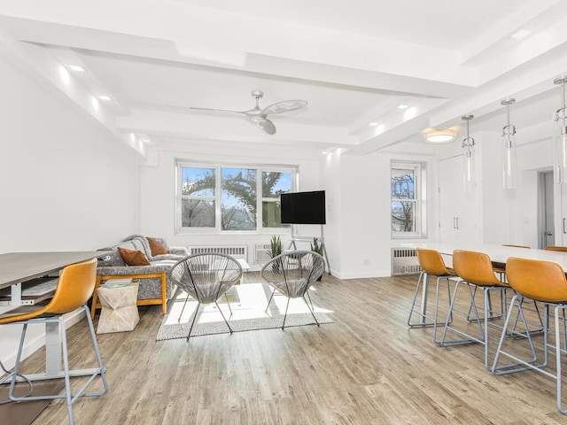 interior space with ceiling fan, radiator heating unit, and light hardwood / wood-style floors