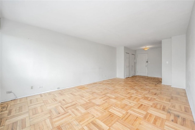 unfurnished room featuring light parquet flooring