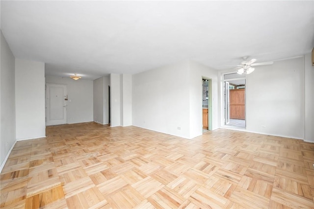 unfurnished room featuring ceiling fan and light parquet flooring