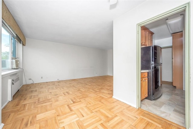 unfurnished living room with light parquet floors