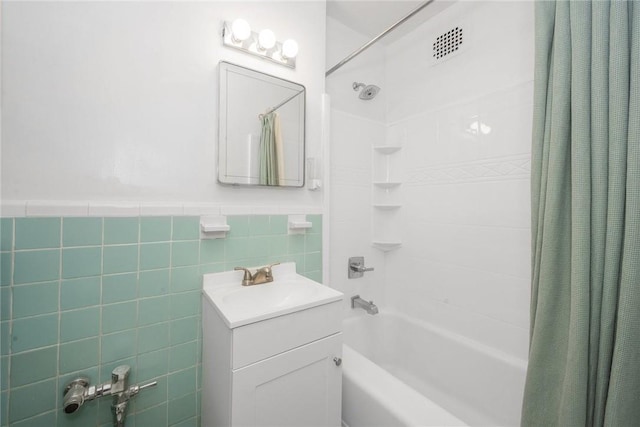 bathroom featuring vanity, shower / tub combo with curtain, and tile walls