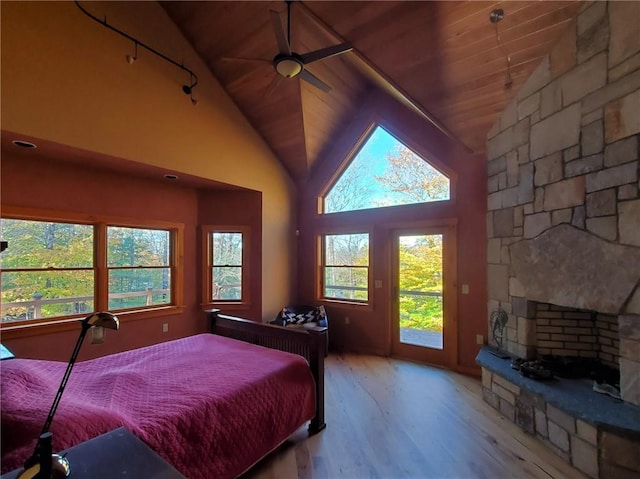 bedroom with multiple windows, ceiling fan, light hardwood / wood-style floors, and wooden ceiling