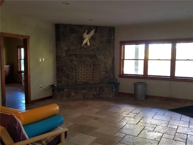 living room featuring a stone fireplace