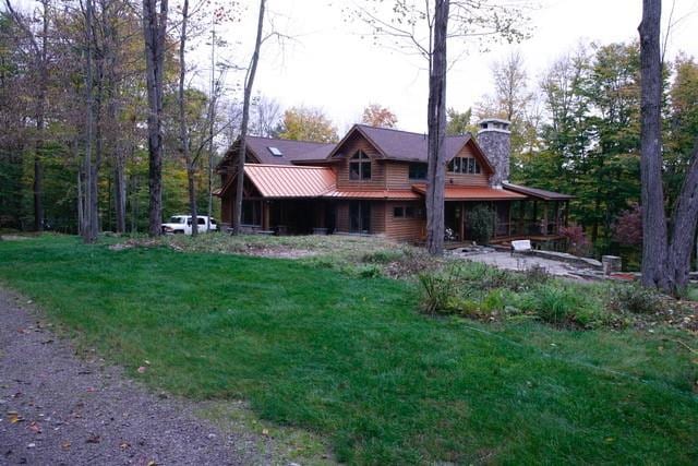 log-style house with a front lawn