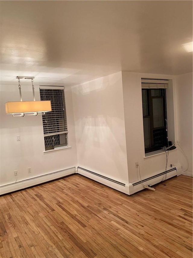 spare room featuring light hardwood / wood-style flooring and baseboard heating