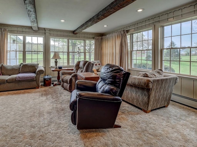 carpeted living room featuring beamed ceiling and plenty of natural light