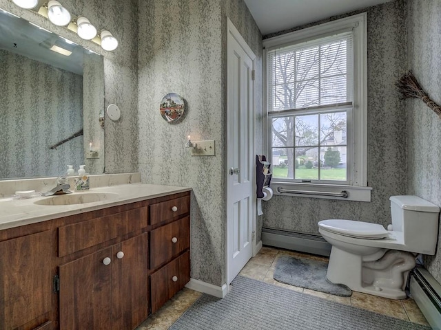 bathroom featuring baseboard heating, tile patterned floors, vanity, and toilet