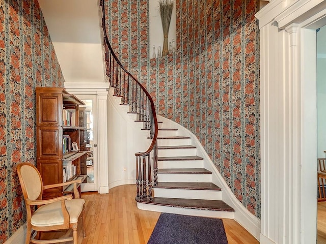 stairway with hardwood / wood-style flooring