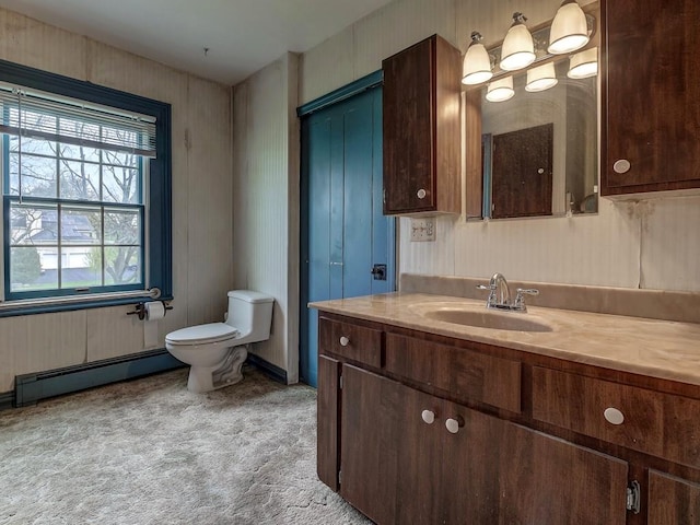 bathroom featuring baseboard heating, vanity, and toilet