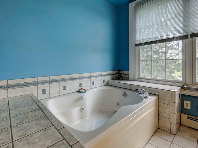 bathroom with tile patterned flooring, baseboard heating, and tiled tub