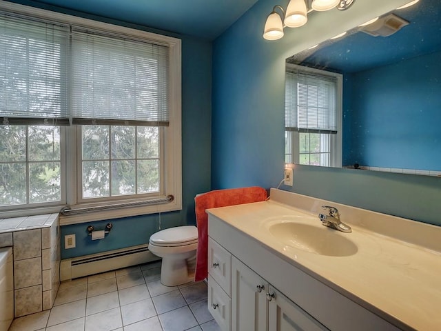 bathroom with vanity, tile patterned floors, a wealth of natural light, and a baseboard heating unit