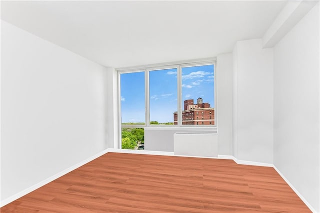 spare room featuring hardwood / wood-style floors