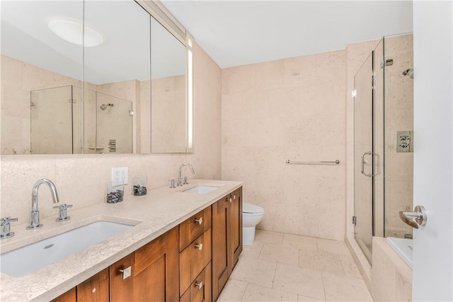 full bathroom with plus walk in shower, toilet, decorative backsplash, vanity, and tile walls