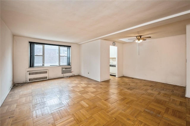 unfurnished room with ceiling fan, radiator heating unit, light parquet flooring, and a wall mounted air conditioner