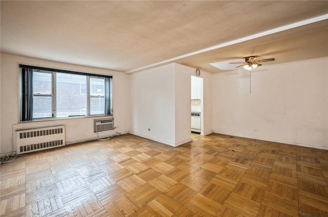 unfurnished room featuring a wall mounted air conditioner, radiator heating unit, light parquet floors, and ceiling fan