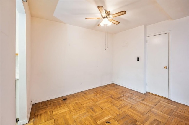 empty room featuring ceiling fan and light parquet flooring