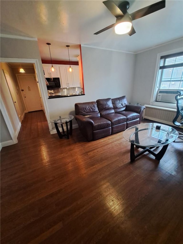 living room with ceiling fan, dark hardwood / wood-style flooring, cooling unit, and crown molding