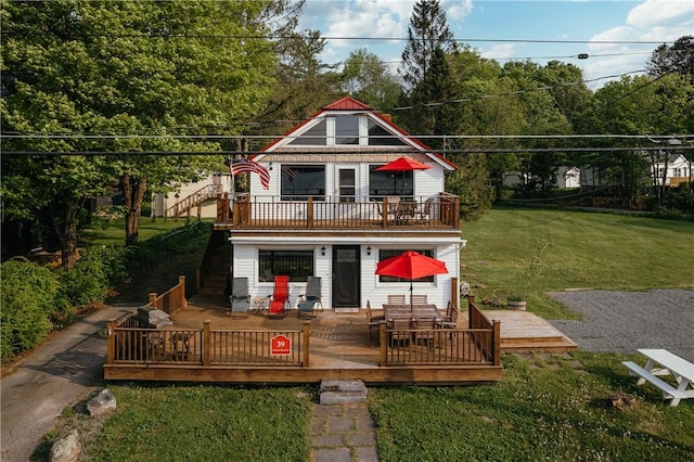 back of property featuring a yard and a wooden deck