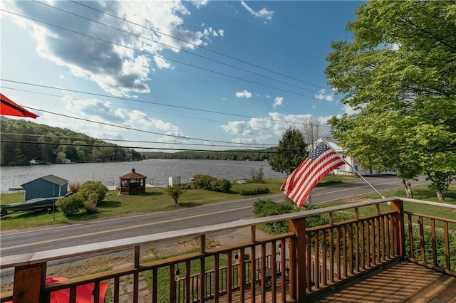 wooden terrace featuring a water view