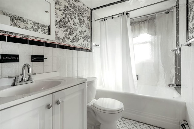 full bathroom with vanity, a baseboard heating unit, toilet, tile walls, and shower / tub combo