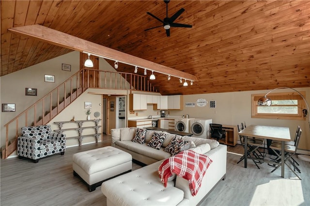 living room with ceiling fan, wooden ceiling, vaulted ceiling with beams, separate washer and dryer, and light hardwood / wood-style flooring