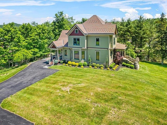 2 Pine Hill Rd, Chester, NY 10918 - victorian-style house with a tiled roof, a front yard, asphalt driveway, and a porch