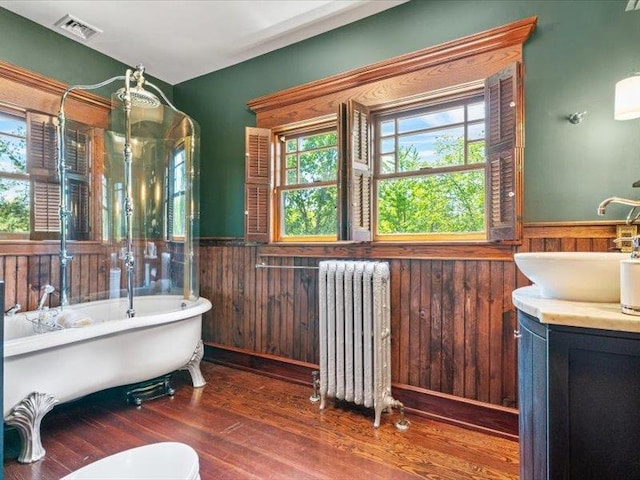 2 Pine Hill Rd, Chester, NY 10918 - full bathroom with radiator, a wainscoted wall, wood finished floors, a freestanding tub, and vanity