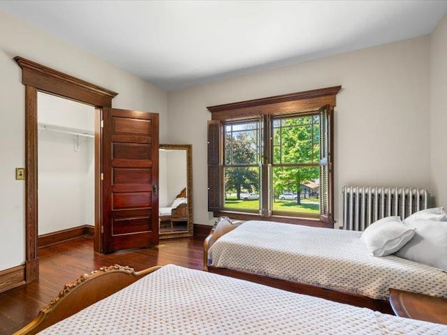 2 Pine Hill Rd, Chester, NY 10918 - bedroom featuring radiator heating unit, wood finished floors, baseboards, and a walk in closet