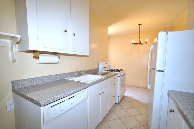 kitchen with sink, white cabinets, decorative light fixtures, and white appliances