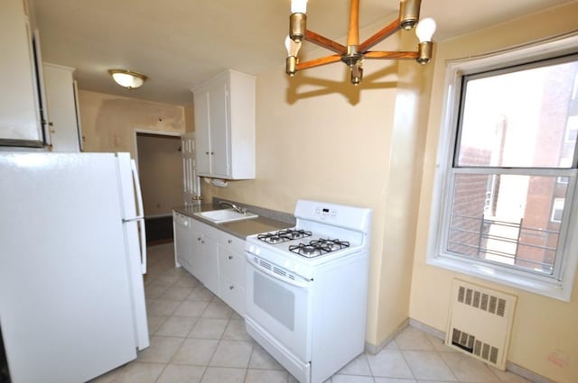 kitchen featuring white cabinets, white appliances, radiator, and sink