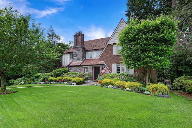 english style home with a front lawn