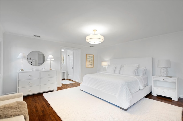 bedroom with dark hardwood / wood-style flooring