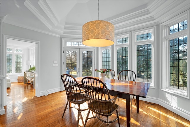 dining room featuring crown molding, light hardwood / wood-style floors, and french doors