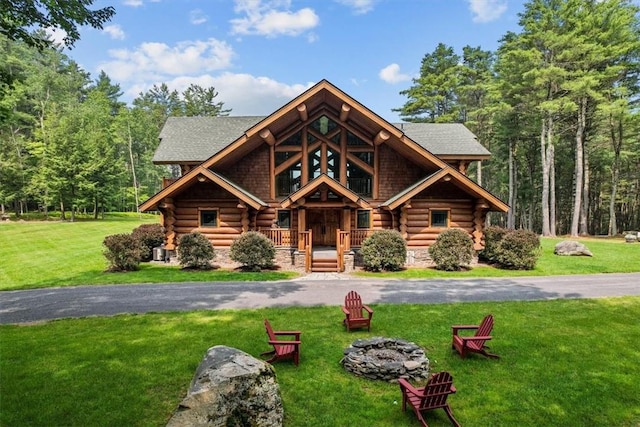 log home with a porch and a front lawn