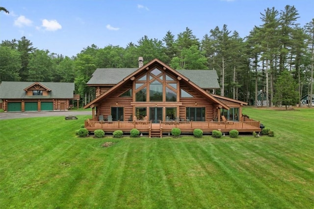 rear view of house featuring a yard and a deck